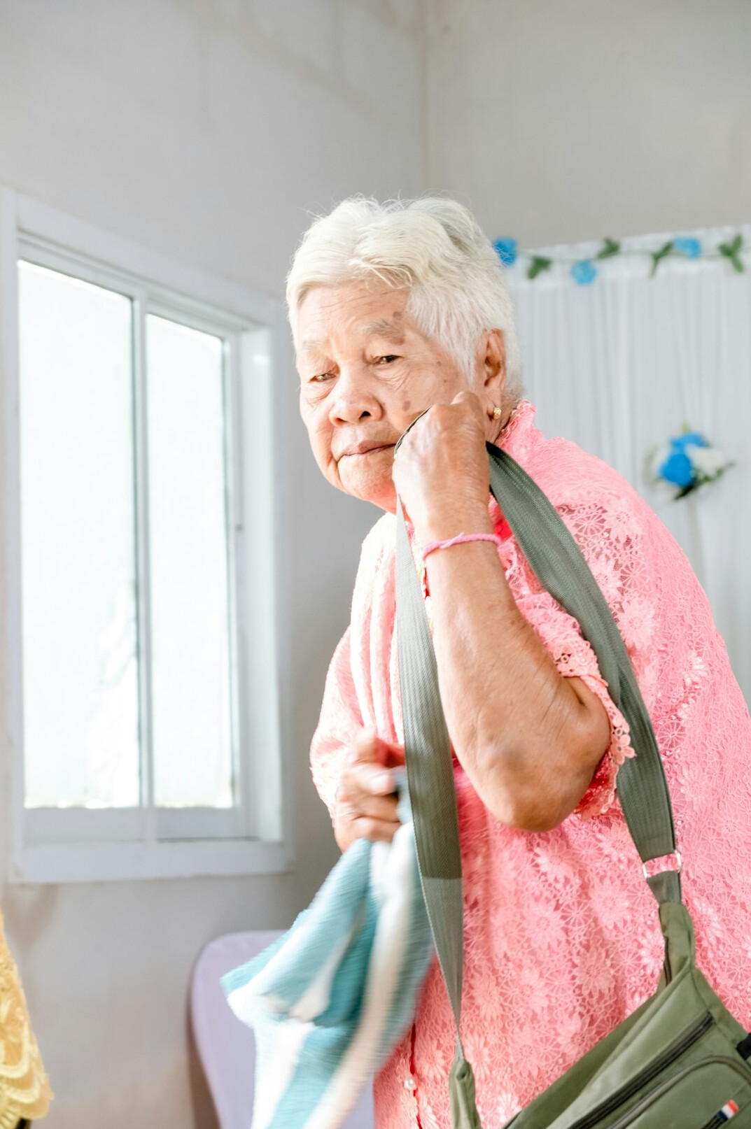 Smiling older woman in a pink knit sweater
