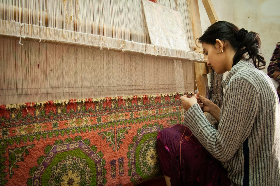woman weaving on loom