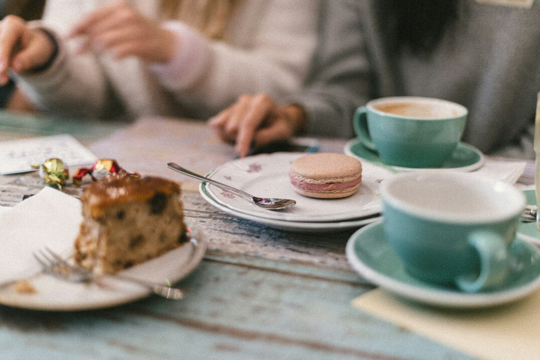 Friends chatting together at a cafe table